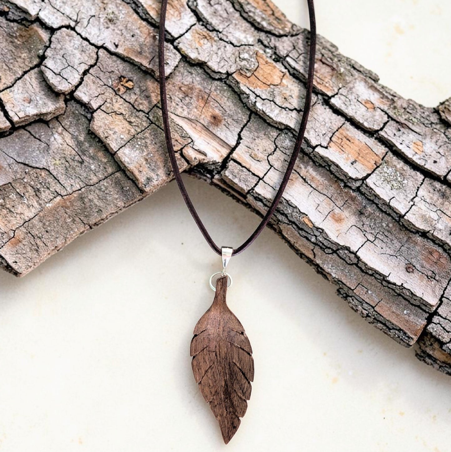 Hand-carved walnut wood pendant