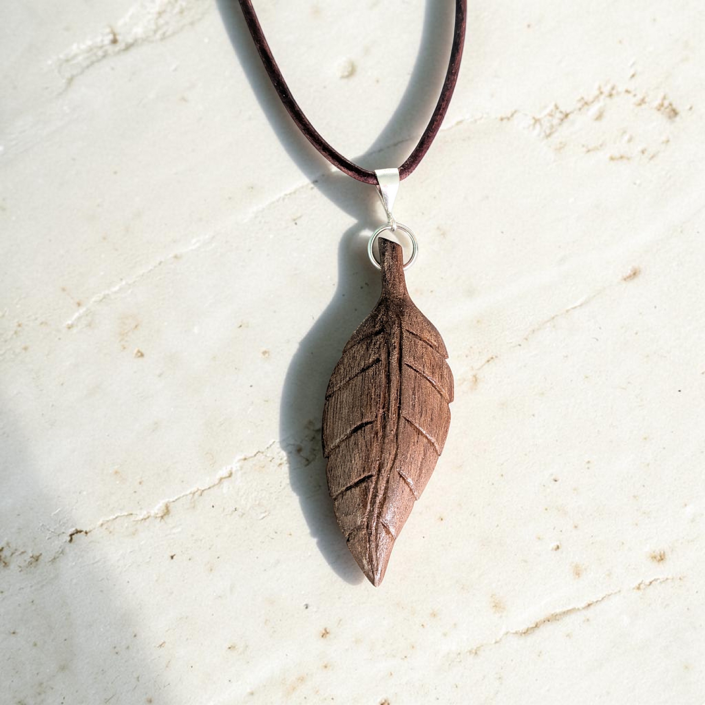 Hand-carved walnut wood pendant