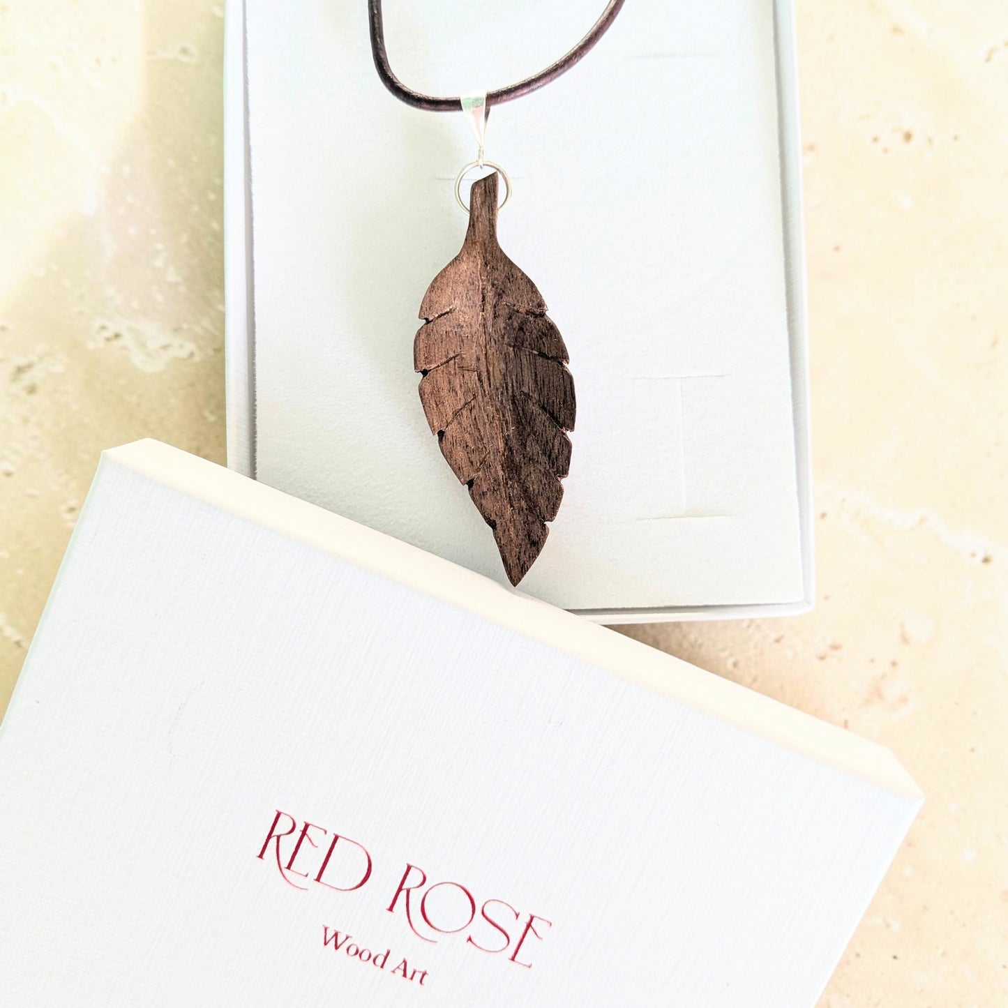 Hand-carved walnut wood pendant
